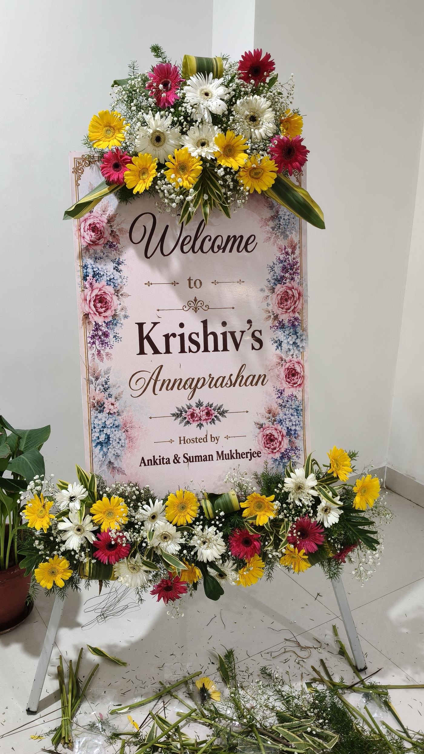 Welcome signboard decorated with colourful gerbera flowers for a baby's Annaprashan ceremony
