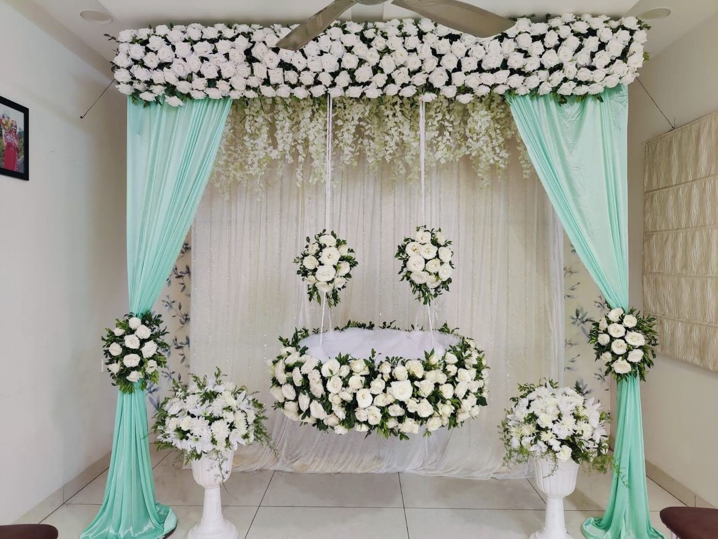 Elegant white rose cradle swing decoration for a naming ceremony