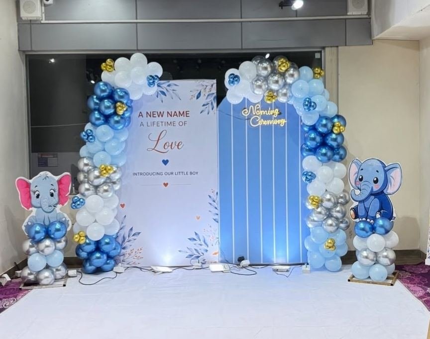 Blue white and gold balloon backdrop for a baby boy naming ceremony