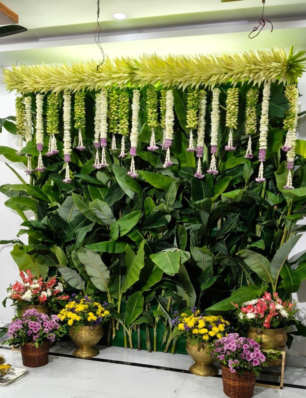 Banana leaf mandap backdrop with white garlands