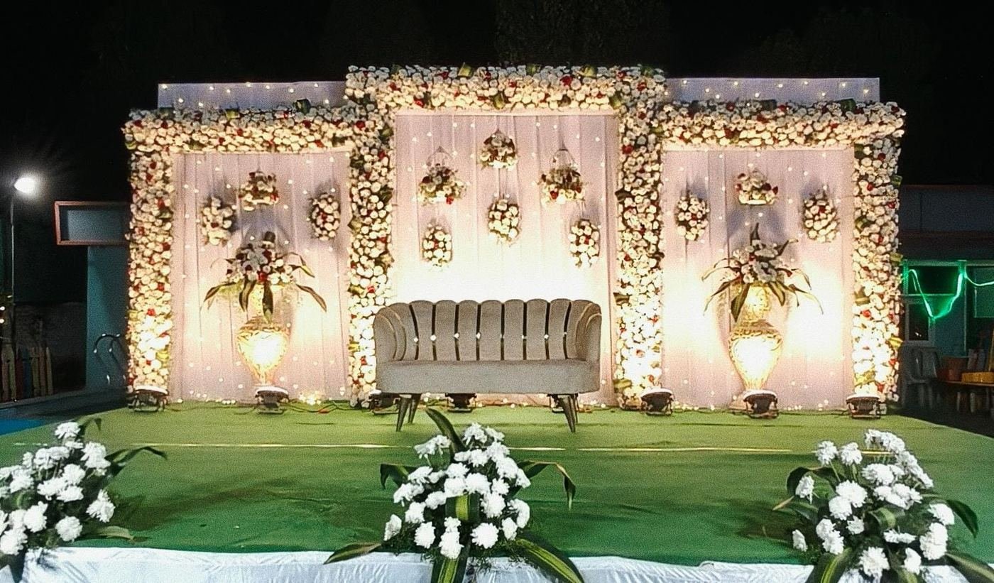 Close-up detail of pink and ivory wedding stage floral swags